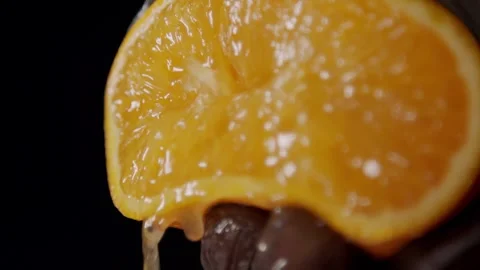 Orange on black background, shooting video from hands Vídeos de archivo 327572202
