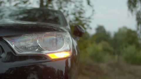 Orange blinker of a black car blinking Stock Footage 211500988