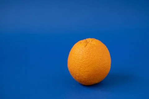 Orange on a blue background Stock Photos