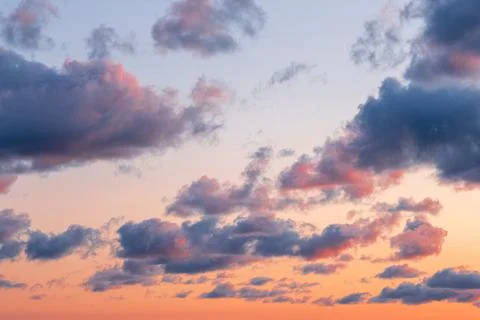 Orange - blue clouds during sunset. Beautiful, colorful dramatic sky background. Stock Photos