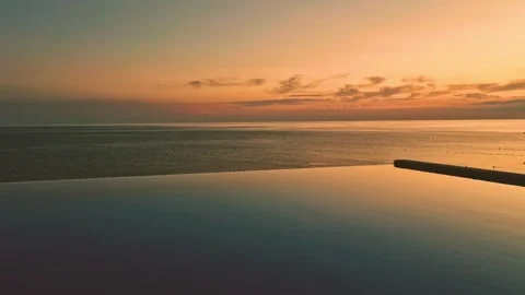 Orange Blue Infinity Pool Ocean Colorful Sky and Cirrus Clouds on the Horizon Sl Stock Footage 279748773