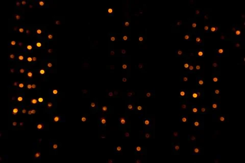 Orange bokeh lights and blurred dots on a dark background, festive abstract Stock Illustration