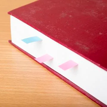 Orange book with sticky note Stock Photos