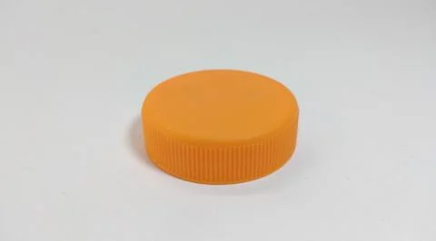 Orange bottle cap for packaged beverage. Stock Photos