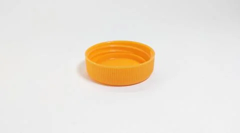 Orange bottle cap for packaged beverage. Stock Photos