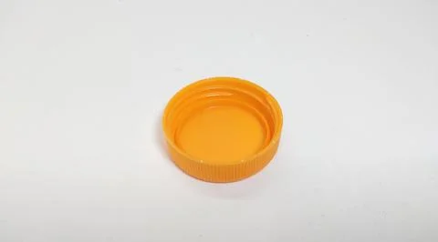 Orange bottle cap for packaged beverage. Stock Photos