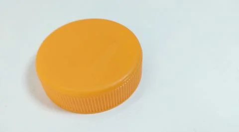Orange bottle cap for packaged beverage. Stock Photos