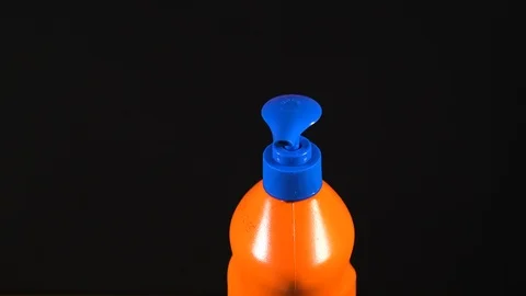 Orange bottle of detergent. Bottle without labels and name. Video stock 124659500