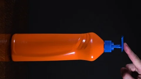 Orange bottle of detergent. Bottle without labels and name. Video stock 124659572