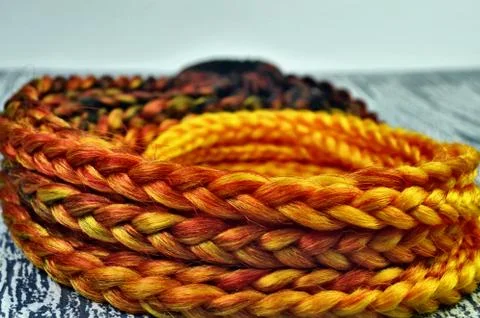 Orange braids on a white background at close range Stock Photos