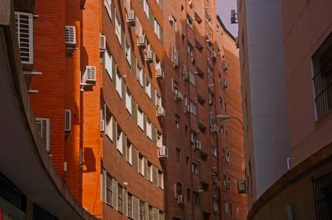 Orange brick building with concave wall Stock Photos