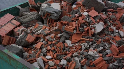 Orange brick debris with remnants of concrete in container Stock Footage 158536341