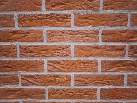 Orange brick facade. Torn stone texture. Stone wall. abstract background Stock Photos