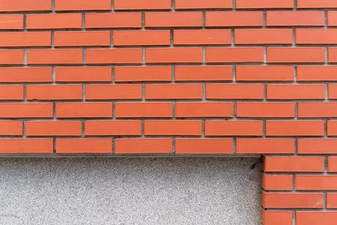 Orange brick wall with a copy space in the bottom of the frame Stock Photos