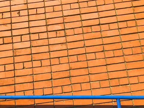 Orange brick wall. Textured background with copy space for design work. Material Stock Photos