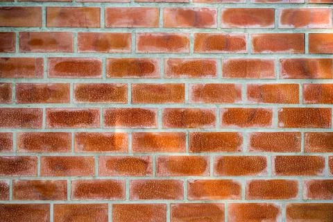 Orange bricks block on cement wall Stock Photos