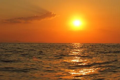 Orange bright sunset under the ocean sun reflection on water scenic yellow .. Stock Photos