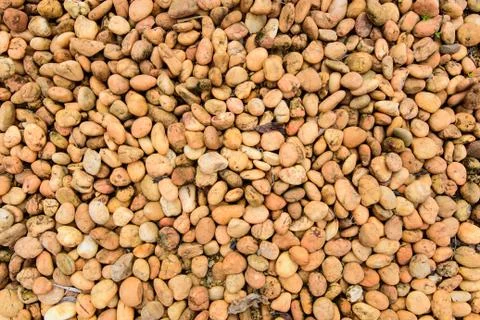 Orange brown rock pebbles background Stock Photos