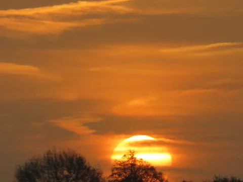 Orange brown sunset sky Stock Photos