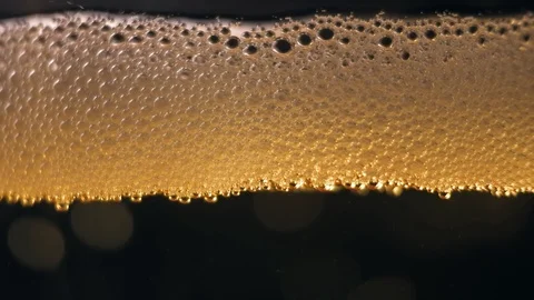 Orange bubbles floating on a liquid beer. Stock Footage 89309328