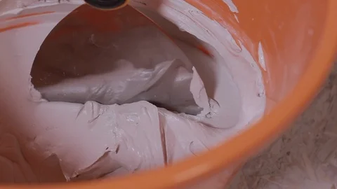 Orange Bucket With A Mixed White Decorative Concrete Plaster Stock Footage 101382858