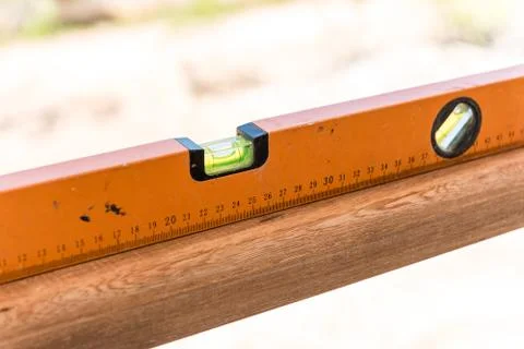 Orange building level on the wood Fotos Stock