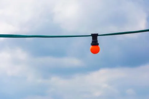 Orange bulb light in a blue cloudy sky Stock Photos