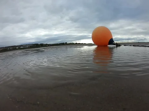 Orange buoy with chain on the sandy beach Stock Footage 151655701