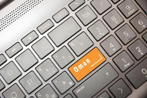 Orange button on the PC with the word Oman Stock-Fotos