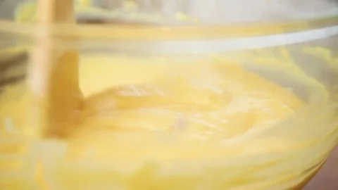 Orange cake batter being mixed in bowl Video stock 76099626