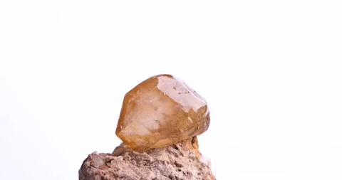 Orange calcite on matrix rotating 360° loop isolated white background Video stock 253099582
