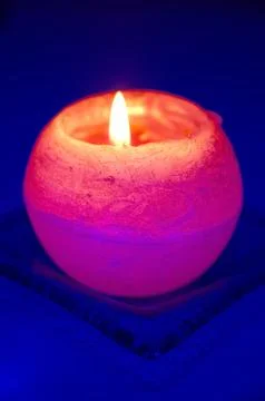 Orange candle on blue background 写真素材