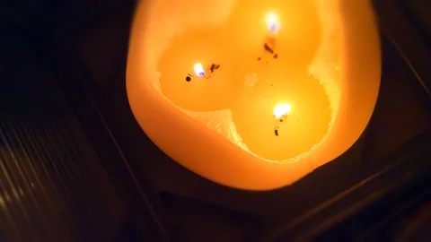 Orange candle burning with three wicks. Stock Footage 88629211