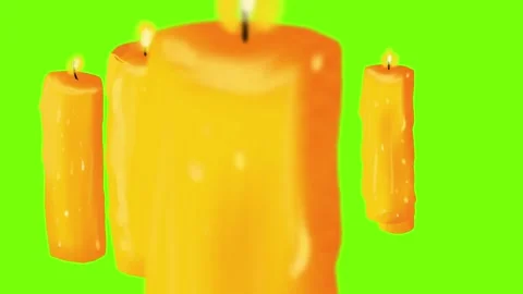 Orange candles flicker softly, creating a warm ambiance against a vivid green Stock Footage 292688572