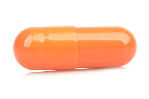 Orange capsule isolated on white background Stock Photos