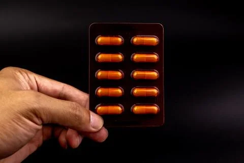 Orange capsules pill in blister pack arranged with beautiful pattern Stock Photos