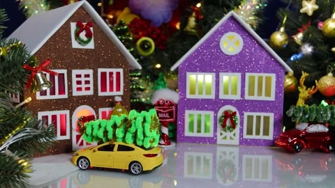 An orange car drives through the town among the fir trees and houses Stock Footage 317533607