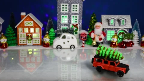 An orange car pulls up to a Christmas town Video stock 308568583