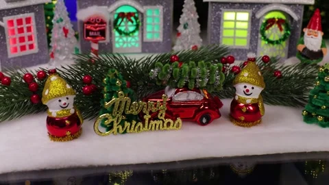 An orange car stops in front of a beautifully decorated Christmas town Stock Footage 341399870
