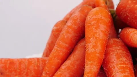 Orange carrots side view, View of orange carrots isolated over white background Vídeo Stock 148218721