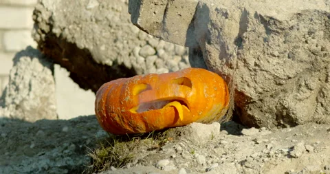 Orange carved pumpkin explodes in slow motion Stock Footage 145054755