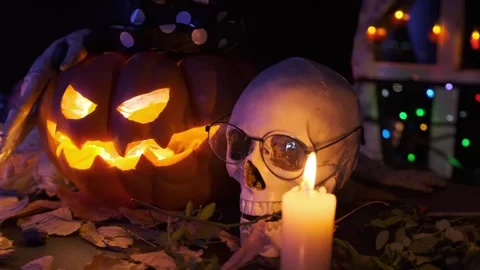 Orange carved pumpkin flashing inside Jack Lantern with human skull Stock Footage 284758411