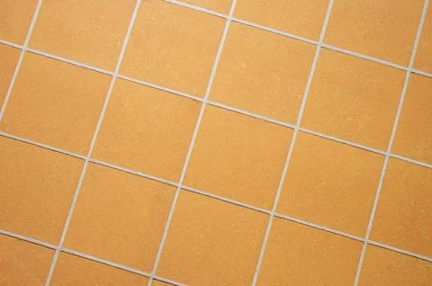 Orange ceramic tile background in a minimalist style. Interior design concept Stock Photos