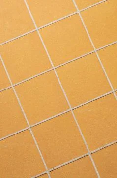 Orange ceramic tile background in a minimalist style. Interior design concept Stock Photos