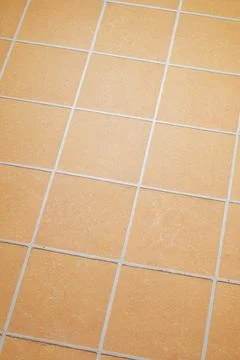 Orange ceramic tile background in a minimalist style. Interior design concept Stock Photos