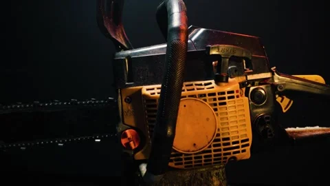Orange chainsaw in a dark room for testing Stock Footage 331283137
