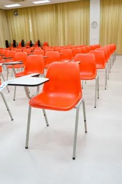 Orange chairs  in classroom Stock Photos