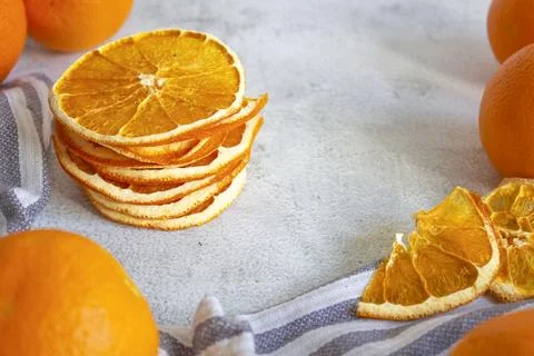 Orange chips on a gray background, close up. Fruit chips. A healthy snack. Stock Photos