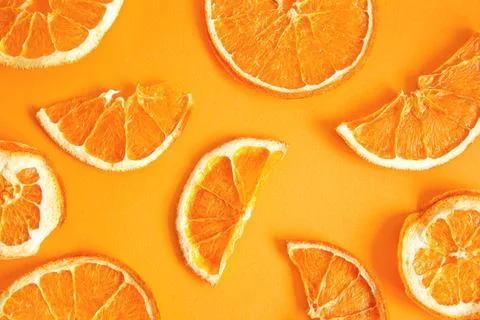 Orange chips on an orange background, top view. A healthy snack. Stock Photos