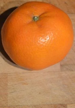 Orange on a chopping board - space for text in the bottom Stock Photos